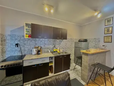 a kitchen with a sink and a stove and a refrigerator at Apartments HMD in Budva