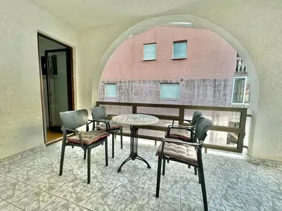 a room with a table and chairs and a window at Apartments HMD in Budva