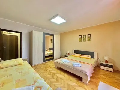 a large bedroom with two beds in it at Apartments HMD in Budva