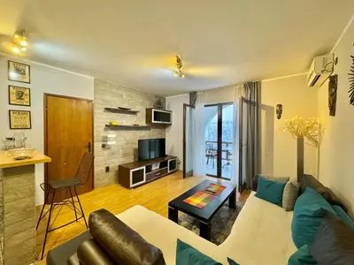 a living room with a couch and a table at Apartments HMD in Budva