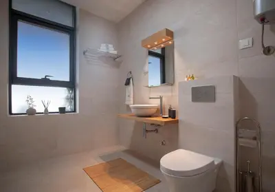 a bathroom with a toilet and a sink and a window at Royal Gardens Paradise in Budva