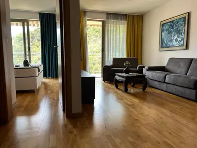 a living room with a couch and a table at Luxury Pool Apartments near the sea in Sveti Stefan