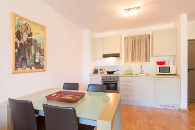 a kitchen with a table and chairs and a dining room at Luxury Pool Apartments near the sea in Sveti Stefan