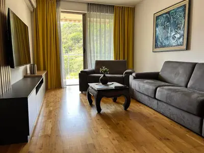 a living room with a couch and a coffee table at Luxury Pool Apartments near the sea in Sveti Stefan