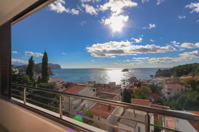 a view of the ocean from a balcony at Apartment Sidro in Petrovac na Moru