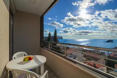 a balcony with a table and a view of the ocean at Apartment Sidro in Petrovac na Moru