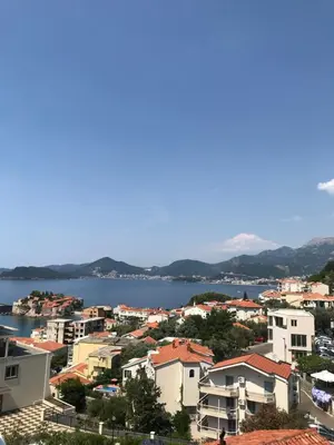 a view of a city and a body of water at Apartments Aleksandar in Sveti Stefan