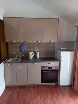 a small kitchen with a sink and a refrigerator at Apartments Budva Center in Budva