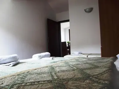 a bedroom with two beds and a window at Apartments Budva Center in Budva