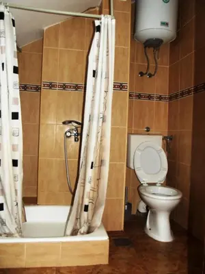 a bathroom with a toilet and a shower curtain at Apartments Budva Center in Budva