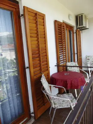 a balcony with a table and chairs and a window at Apartments Budva Center in Budva