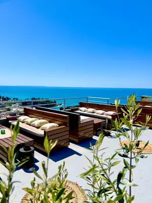 a group of beds on a beach near the ocean at Apartments Tati in Ulcinj