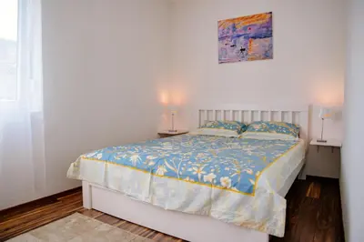 a bedroom with a bed and two night stands at Peaceful City Center in Podgorica