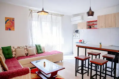 a living room with a couch and a table at Peaceful City Center in Podgorica