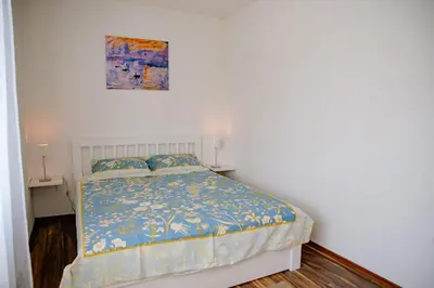 a bedroom with a bed and a painting on the wall at Peaceful City Center in Podgorica