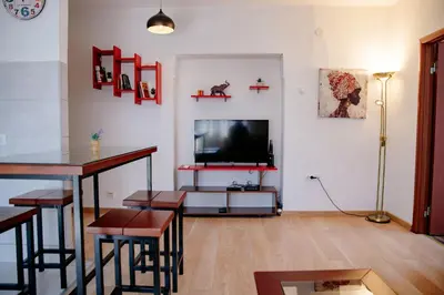 a living room with a flat screen tv on a wall at Peaceful City Center in Podgorica