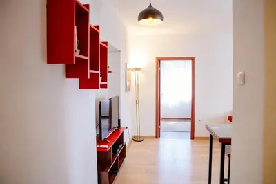 a living room with a television and a table at Peaceful City Center in Podgorica