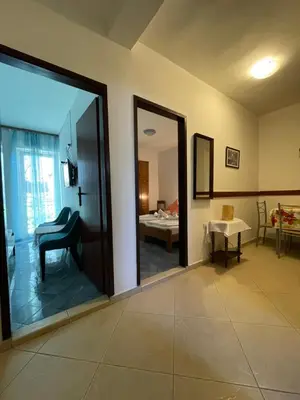 a room with a large sliding glass door with a bedroom at Apartments Marković in Budva