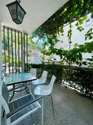 a table and chairs on a balcony with a view at Apartments Marković in Budva