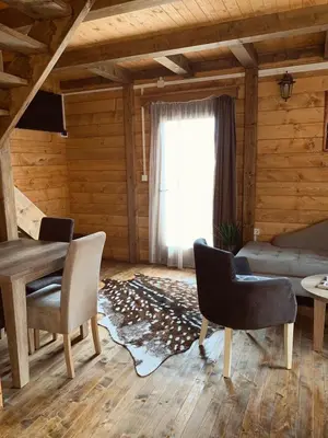a living room with a couch and chairs and a window at Apartments 