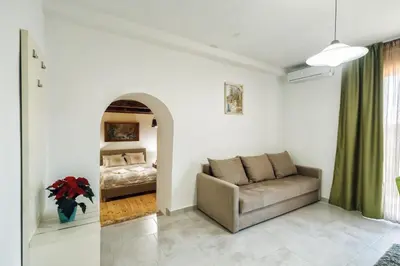 a living room with a couch and a bed at Apartments 
