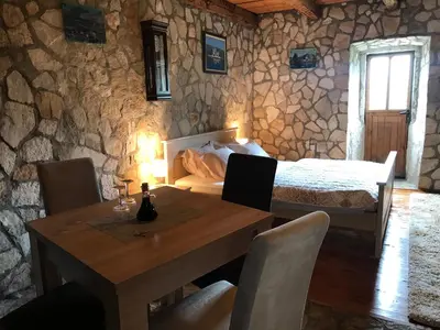 a dining room with a table and a bed at Apartments 