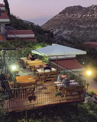 a group of people sitting at tables at a restaurant at Apartments 