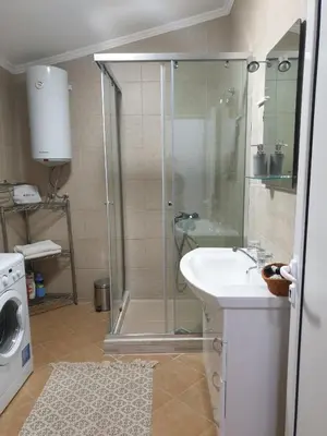 a bathroom with a shower with a sink and a shower at Apartments 