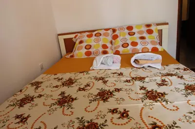 a bed with two towels on top of it at Guest House Olga in Budva