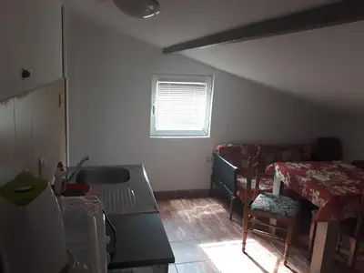 a living room with a couch and a table at Guest House Olga in Budva