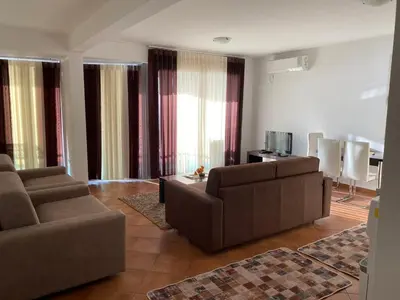 a living room with two couches and a tv at Apartments Palma in Dobra Voda