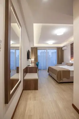 a hotel room with a bed and a mirror at Hotel Twelve by Aycon in Budva