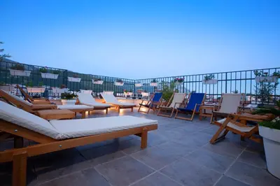 a row of chairs and tables on a roof at Hotel Twelve by Aycon in Budva