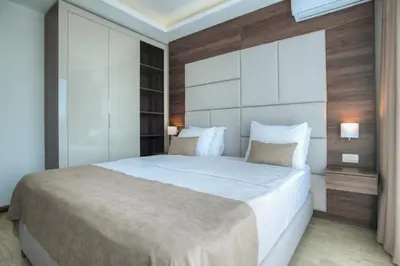 a bedroom with a large white bed with two pillows at Hotel Twelve by Aycon in Budva