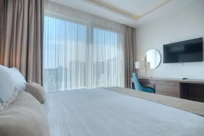 a hotel room with a bed and a large window at Hotel Twelve by Aycon in Budva