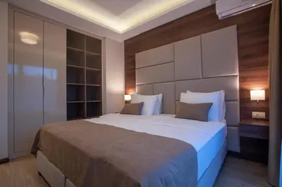a bedroom with a large bed with a large headboard at Hotel Twelve by Aycon in Budva