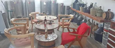 a group of tables and chairs in a room with vases at Vila Pegaz in Virpazar