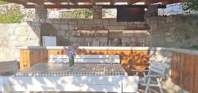 a table with a vase of flowers on top at Vila Pegaz in Virpazar