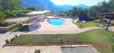 a view of a swimming pool with mountains in the background at Vila Pegaz in Virpazar