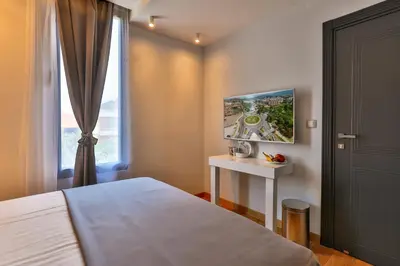 a bedroom with a bed and a window at Hotel M in Podgorica
