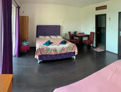 a bedroom with a bed and a table with chairs at Villa Dulsinea in Ulcinj