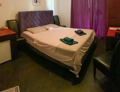 a bedroom with a bed with a purple head board at Villa Dulsinea in Ulcinj