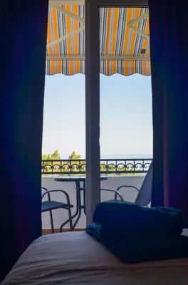 a bedroom with a bed and a view of the ocean at Villa Dulsinea in Ulcinj