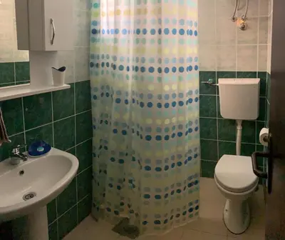 a bathroom with a shower with a toilet and a sink at Villa Dulsinea in Ulcinj