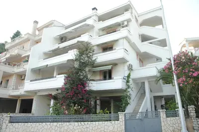 a white building with flowers in front of it at Villa Dulsinea in Ulcinj