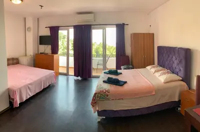 a bedroom with two beds and a balcony at Villa Dulsinea in Ulcinj