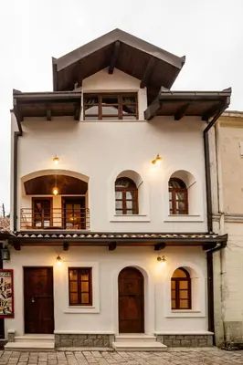 a white house with windows and a balcony at Villa Irma in Bar