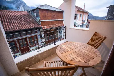 a wooden table and two chairs on a balcony at Villa Irma in Bar