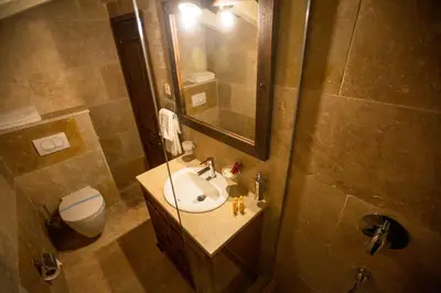 a bathroom with a sink and a toilet and a mirror at Villa Irma in Bar