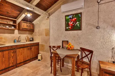 a kitchen with a table and chairs in a room at Villa Irma in Bar
